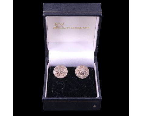 A pair of artisan-made silver stud earrings by Michael King of Curthwaite, each of sea-urchin-like form, being radially-stria