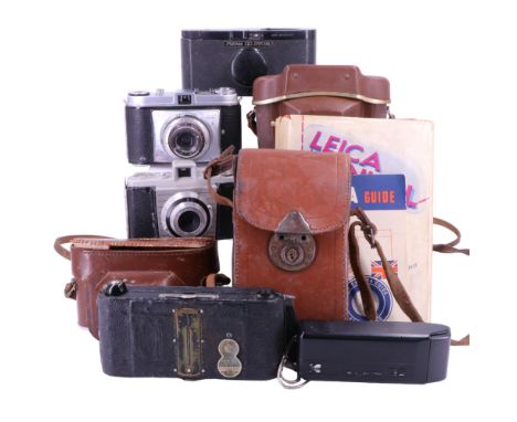 Three vintage rollfilm cameras including a black Bakelite Purma Special, a 1950s Kodak Bantam Colorsnap and a Retinette toget