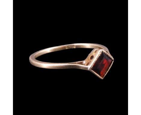 A vintage garnet finger ring, comprising a square-cut stone of approx 0.75 ct, bezel-set on a tapering geometrically-pierced 