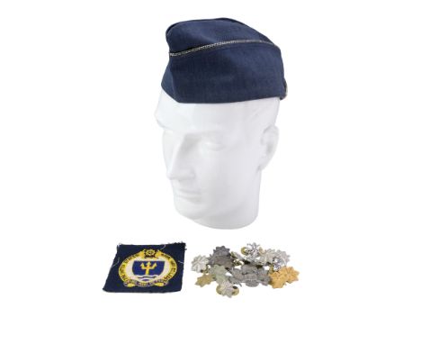 A US Air Force officer's garrison cap together with an Army officer's cap badge, a US Naval War College badge and sundry item