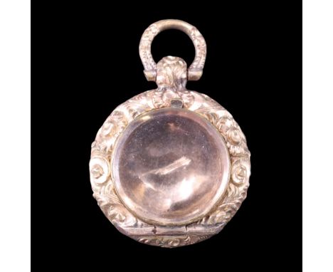 A small Victorian gold pendant locket, the circular fob having a small hinged bevel-edged glass within a floral bezel, decora