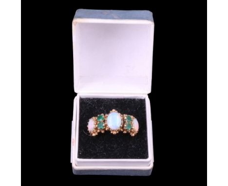 A 19th Century style opal and emerald ring, comprising three oval opal cabochons divided by pairs of round-cut emeralds, claw