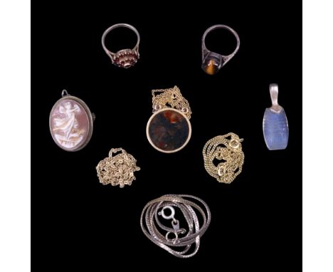 A small group of vintage costume jewellery including a moss agate circular plaque pendant, a garnet cluster ring, a tiger's e