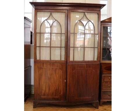 A late 19th / early 20th Century Sheraton revival string inlaid and cross banded mahogany wardrobe having a pair of glazed an