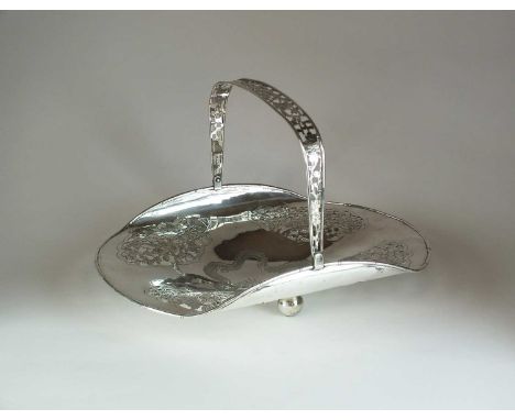 A Chinese silver swing handled basket, Wang Hing, the centre engraved with a four clawed dragon within four decorative floral
