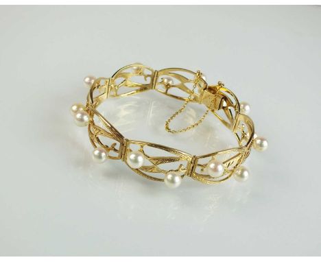 A Mikimoto cultured pearl bracelet, designed as eight rounded rectangular openwork panels each set with two cultured pearls, 