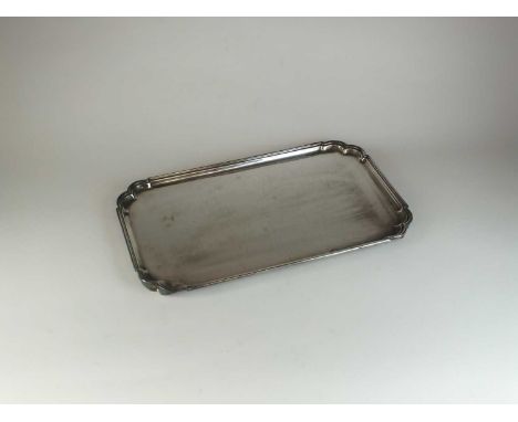 A silver tray, Roberts &amp; Belk, Sheffield 1965, of elongated rectangular form with lobed corners and raised on four bracke