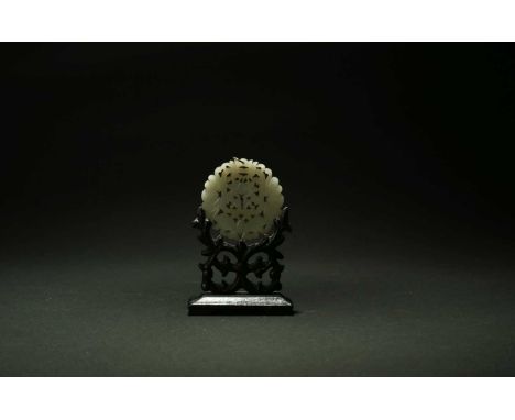 A Chinese pale green jade pendant, Qing Dynasty, 19th centuryOf circular form, carved and pierced with two bats and a butterf