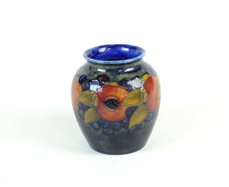 A William Moorcroft vasecirca 1930sof ovoid form, tubelined with pomegranates and leaves against a dark blue ground, impresse