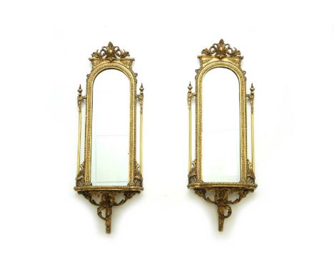 A pair of Victorian giltwood wall mirrors, second half 19th centuryThe narrow plates with arched tops within beaded frames, s
