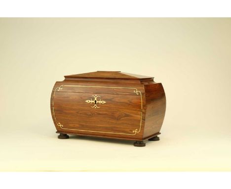 A mid-Victorian brass inlaid rosewood tea caddy, circa 1870Of sarcophagus form on turned feet, inlaid with brass scroll lines