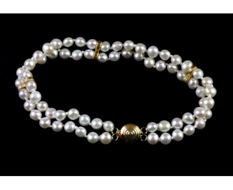 A double row cultured pearl bracelet on a 14ct yellow gold clasp, L. 17cm.