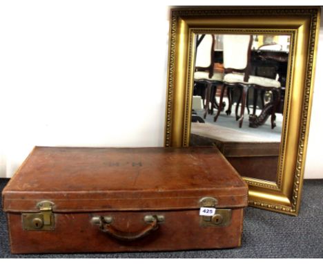 A vintage leather case and a gilt mirror.