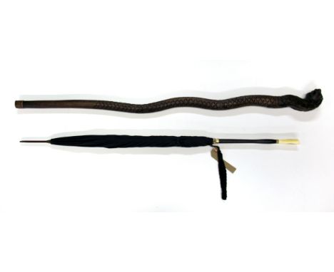 An early 20th century carved Chinese design ivory and ebony handled parasol, together with a hardwood carved walking stick in