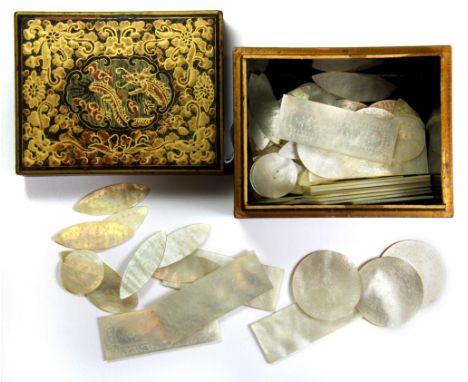 A 19thC Chinese gilt lacquered box containing a quantity of engraved mother of pearl gaming counters, 11 x 8 x 7cm.