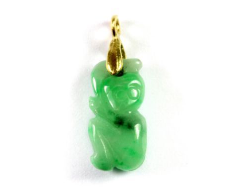 A yellow metal mounted carved apple green jade pendant, L. 2cm.