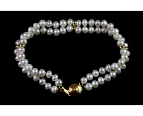 A double row cultured pearl bracelet on a 14ct yellow gold clasp, L. 17cm.