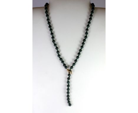 An adjustable spinach jade / hardstone bead necklace on a yellow metal (tested 9ct gold) clasp.