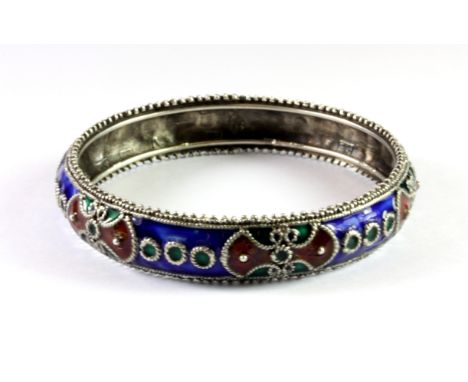 An Indian white metal enamelled bangle.