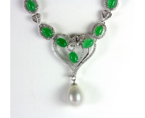 A white metal necklace set with polished apple green jade and a pearl.
