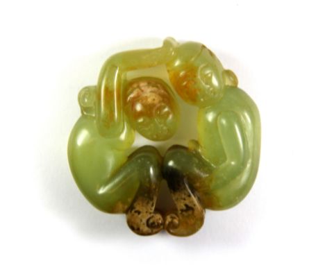 A Chinese carved erotic nephrite jade amulet, Dia. 5.5cm.