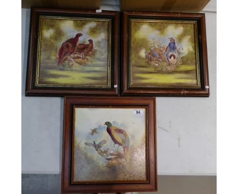 A collection of 3 framed hand painted ceramic tiles with illustrations of game birds  