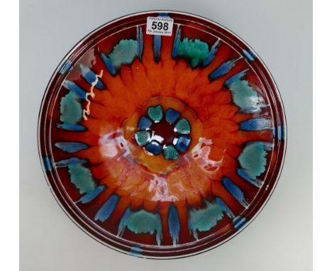 Poole pottery Studio pottery charger decorated in blue, red & green volcano design, diameter 36cm.
