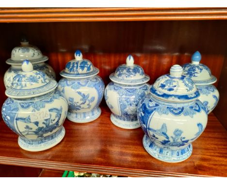 Shelf of Chinese blue and white temple jars. 