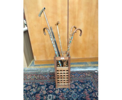 Contemporary umbrella/ walking stick stand with collection of souvenir walking sticks etc. 