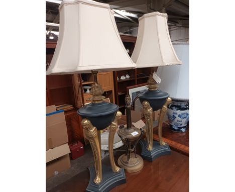 Pair of eastern brass support table lamps together with ornate table lamp with ram heads. 