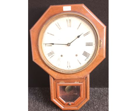 Antique clock, the clock face framed by an octagonal wooden frame, the lower section opening to printed instructions and pend