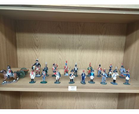 Shelf of various lead soldiers includes cannon horse and rider soldiers etc . 