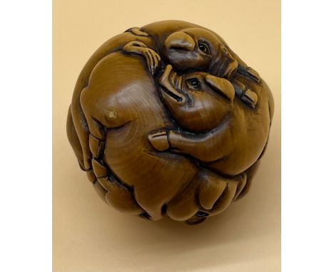Japanese hand carved netsuke sculpture of a group of pigs huddled together, fitted with black bead eyes and signed by the art