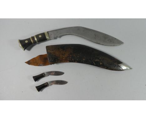 A Vintage Kukri Knife with Leather Scabbard and Two Small Daggers 