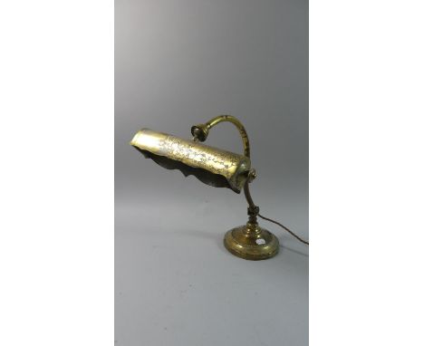 A Vintage Brass Desk Top Reading Lamp with Hinged and Ball Joints on Circular Plinth