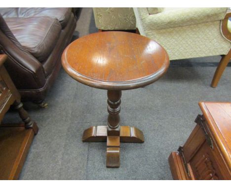 A round oak lamp table, 57cm high x 38cm diameter