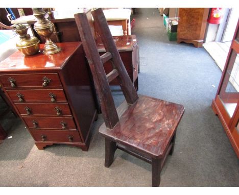 A rustic chair with tapering ladder back