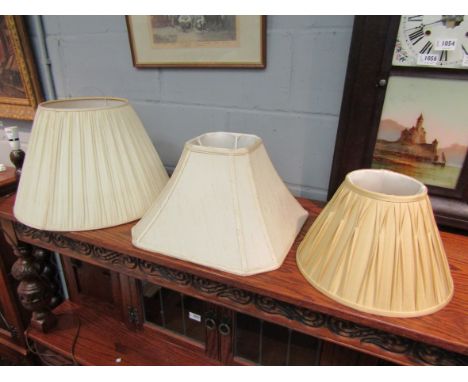 Three cream silk pleated lamp shades