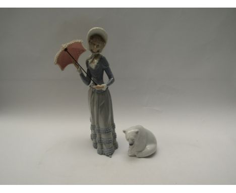 A Lladro figurine "Aranjuez little lady with parasol", model No. 4879 together with a Lladro Polar bear seated, model No. 120