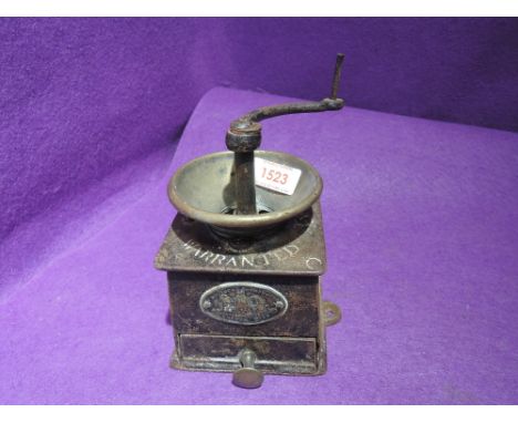 An antique coffee grinder by Bullock and co