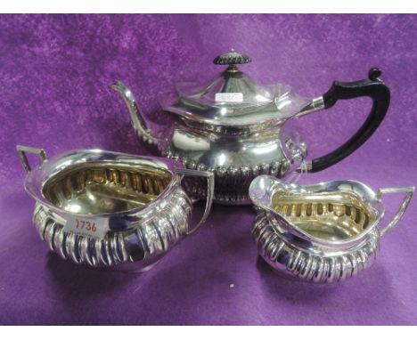 A silver plated matched three piece tea set having Hard wood handle and finial with bun feet to tea pot