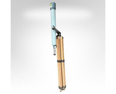 A vintage telescope on folding tripod stand.