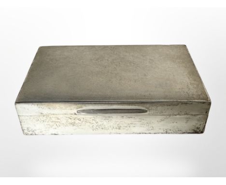 A silver cigarette box with engine turned decoration, Walker & Hall Ltd, Sheffield date letter rubbed, width 14.5 cm.