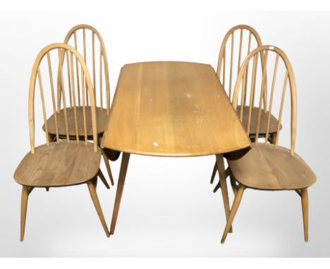 An Ercol elm and beech drop leaf dining table, 113 cm x 123 cm (extended) and a set of four spindle back dining chairs.