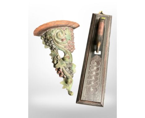 A Scandinavian painted pine mangle board, length 60 cm and a painted wall bracket in the form of a bushel of grapes 