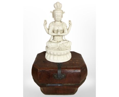 An oriental lacquered wood caddy, height 29 cm, and a porcelain figure of Buddha in lotus pose.