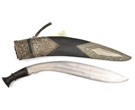 An old kukri,  double shallow fullered blade 15½”, with short back fuller, darkwood grip with raised central band, in its lea