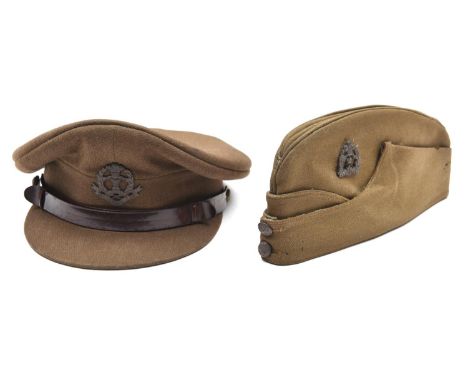 An officer’s khaki peaked cap of The Middlesex Regt, brown leather chinstrap, bronzed badge and buttons, leather headband lin