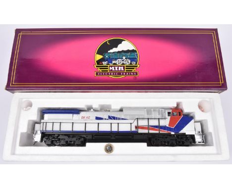 An O Gauge MTH Electric Trains 2-rail American outline Dash-9 diesel locomotive, 2001, in silver, red and blue GE Demo livery