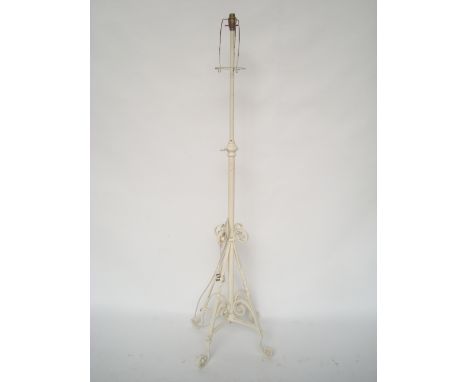 A white painted wrought iron standard lamp. 